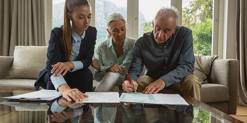 A lawyer explaining power of attorney to a senior client.